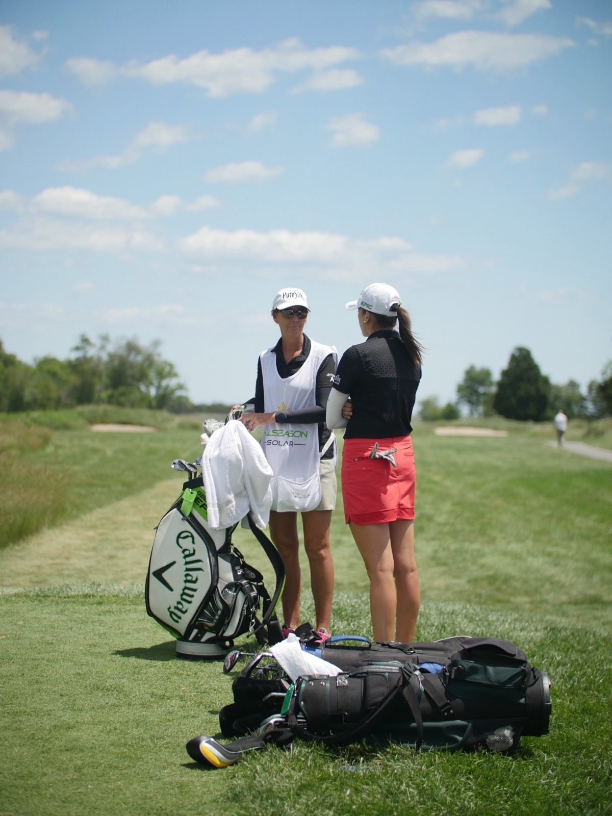 LPGA players walking the course with their bags